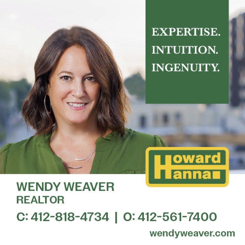 woman with brown hair and green shirt smiling in real estate ad